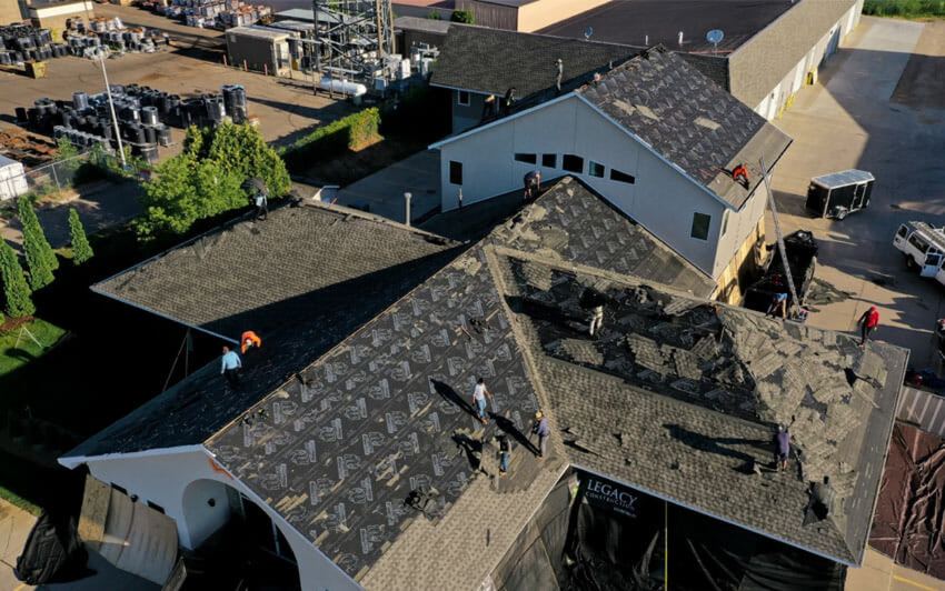 Crew performing a commercial building roof replacement